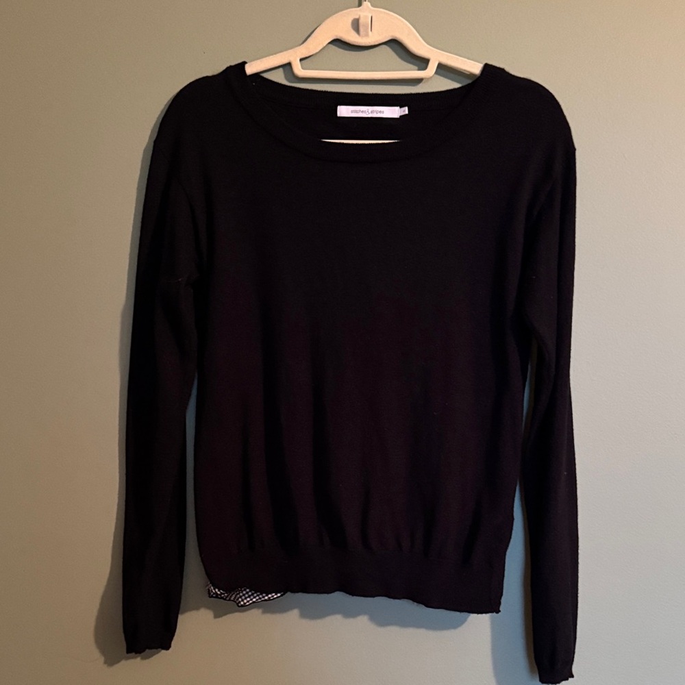 Adorable black very light weight sweater/top with beautiful details in the back.